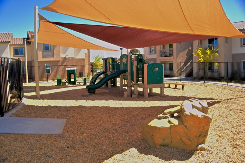 Community playground beside a residential building